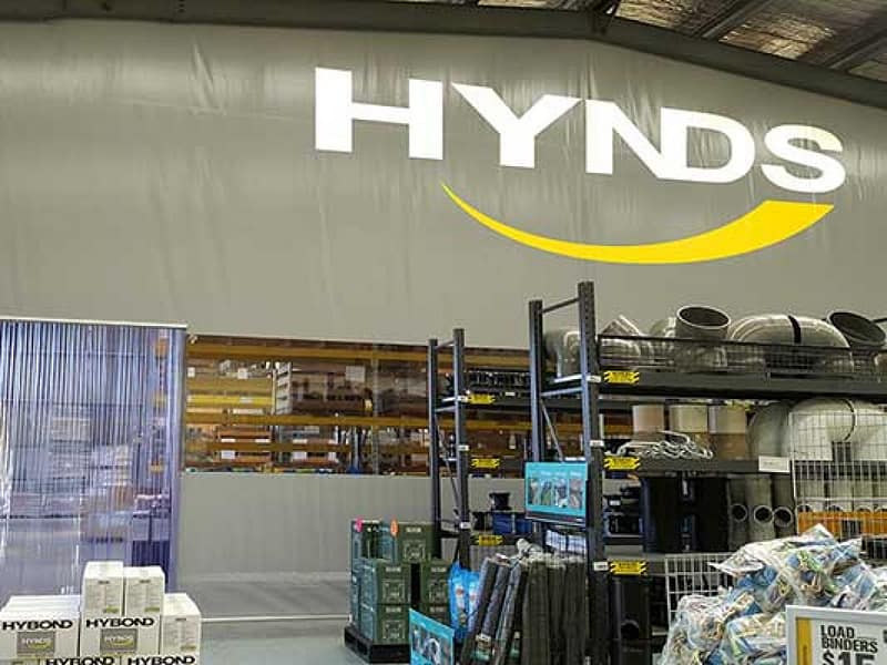 Large industrial curtain wall separating warehouse zones at a Hynds facility.